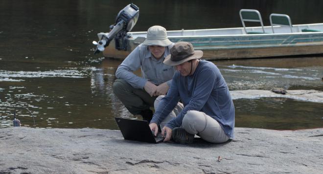 Image of Jan and me examining data on a riverbank